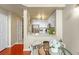 Cozy kitchen features white cabinetry, stainless steel appliances, and a charming dining area with a glass table at 700 S Harbour Island Blvd # 105, Tampa, FL 33602