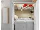 Neat laundry closet with front loading washer and dryer and ample shelf space at 700 S Harbour Island Blvd # 105, Tampa, FL 33602