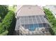 Aerial view of a home featuring an enclosed patio with a pool at 7334 Night Heron Dr, Land O Lakes, FL 34637