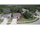 Aerial view of a charming two-story home featuring mature trees, a well-maintained lawn, and a two car garage at 7334 Night Heron Dr, Land O Lakes, FL 34637