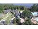 Stunning aerial view of the expansive property showcasing lush landscaping, multiple buildings, and resort style pool at 7334 Night Heron Dr, Land O Lakes, FL 34637