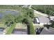 Aerial view of the private backyard with screen enclosed pool, lush greenery and pond views at 7334 Night Heron Dr, Land O Lakes, FL 34637