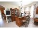 Stylish bar area with wooden cabinetry, tile flooring, decorative shelving, and natural light from the window at 7334 Night Heron Dr, Land O Lakes, FL 34637