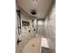 Modern bathroom with sleek fixtures, gray marble tile, rainfall shower, bench, and shower niche at 7334 Night Heron Dr, Land O Lakes, FL 34637