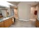 Bathroom featuring a double vanity with dual sinks and a walk-in shower with tile surround at 7334 Night Heron Dr, Land O Lakes, FL 34637