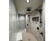 Luxurious bathroom featuring gray marble tile, rainfall shower head, shower niche, and built-in bench at 7334 Night Heron Dr, Land O Lakes, FL 34637