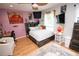 Cozy bedroom with hardwood floors and a custom headboard and unique decorations at 7334 Night Heron Dr, Land O Lakes, FL 34637