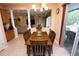 Dining room with a chandelier and a view of the living room and backyard at 7334 Night Heron Dr, Land O Lakes, FL 34637