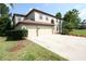 Charming two-story home featuring a well-maintained lawn, mature trees, and a three car garage at 7334 Night Heron Dr, Land O Lakes, FL 34637