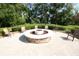 Inviting outdoor fire pit area with ample seating, perfect for entertaining guests amidst beautiful landscaping at 7334 Night Heron Dr, Land O Lakes, FL 34637