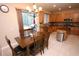 Bright eat-in kitchen with wood cabinets, island, stainless steel appliances, and dining table at 7334 Night Heron Dr, Land O Lakes, FL 34637