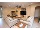 Comfortable living room with neutral paint, tile flooring, plush couches, and a large entertainment center at 7334 Night Heron Dr, Land O Lakes, FL 34637
