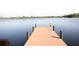 Wooden pier with a ladder providing access to the lake at 7334 Night Heron Dr, Land O Lakes, FL 34637