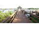 Lakeside pier with covered gazebo, lake views and boating access at 7334 Night Heron Dr, Land O Lakes, FL 34637