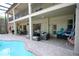 Relaxing outdoor space with a large pool, covered patio, and lounge furniture at 7334 Night Heron Dr, Land O Lakes, FL 34637