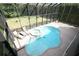 Aerial view of screened-in pool with hot tub and patio, offering a private and relaxing outdoor space at 7334 Night Heron Dr, Land O Lakes, FL 34637