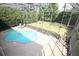 Aerial view of a screened-in pool with a hot tub and backyard area, perfect for outdoor fun and relaxation at 7334 Night Heron Dr, Land O Lakes, FL 34637