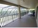 Spacious screened-in porch with railings and outdoor seating, perfect for relaxation and enjoying the view at 7334 Night Heron Dr, Land O Lakes, FL 34637