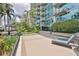 Exterior view of the building featuring manicured landscaping and lounge chairs for residents at 777 N Ashley Dr # 1011, Tampa, FL 33602