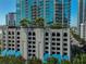 Condominium building with a stylish parking garage and lush landscaping at 777 N Ashley Dr # 1011, Tampa, FL 33602