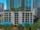 Condominium building with a stylish parking garage and lush landscaping at 777 N Ashley Dr # 1011, Tampa, FL 33602