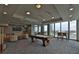 Well lit game room featuring a pool table, lounge area, large screen television, and city skyline views at 777 N Ashley Dr # 1011, Tampa, FL 33602