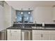 Modern kitchen with stainless steel appliances, sleek black countertops, and white cabinets at 777 N Ashley Dr # 1011, Tampa, FL 33602