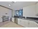 Bright kitchen features stainless steel appliances, white cabinetry, and sleek black countertops at 777 N Ashley Dr # 1011, Tampa, FL 33602