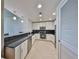 Well-lit kitchen features stainless steel appliances, tiled backsplash, and white cabinetry at 777 N Ashley Dr # 1011, Tampa, FL 33602