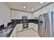 Well-equipped kitchen with stainless steel appliances, black backsplash, and modern design at 777 N Ashley Dr # 1011, Tampa, FL 33602