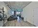 Bright living room featuring a comfortable gray sectional, concrete ceilings, and a view to the outdoor balcony at 777 N Ashley Dr # 1011, Tampa, FL 33602
