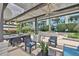 Shaded patio area featuring seating, landscaping, and community building views at 777 N Ashley Dr # 1011, Tampa, FL 33602