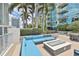 Modern community patio area featuring comfortable seating, a fire pit, landscaping and city views at 777 N Ashley Dr # 1011, Tampa, FL 33602