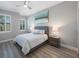 Comfortable bedroom with a ceiling fan, plank flooring and an abundance of natural light at 789 Grand Cypress Ln, Tarpon Springs, FL 34689