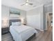 This bedroom features a ceiling fan, plank flooring, neutral colors, and an attached wardrobe at 789 Grand Cypress Ln, Tarpon Springs, FL 34689