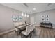 Dining room with a wood table, upholstered chairs, decorative wall art, and modern lighting at 789 Grand Cypress Ln, Tarpon Springs, FL 34689