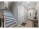 Welcoming entryway with light wood floors, staircase, and neutral paint, leading to the front door at 789 Grand Cypress Ln, Tarpon Springs, FL 34689