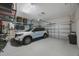 Well-lit two car garage with epoxy floors providing ample space for storage and parking at 789 Grand Cypress Ln, Tarpon Springs, FL 34689