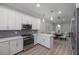 Modern kitchen with white cabinets, stainless steel appliances, and an open layout to the dining area at 789 Grand Cypress Ln, Tarpon Springs, FL 34689