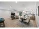 Open-concept living room and dining area showcasing hardwood floors and an adjacent modern kitchen at 789 Grand Cypress Ln, Tarpon Springs, FL 34689