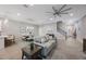 Open-concept living room and dining area featuring modern decor and a stylish ceiling fan at 789 Grand Cypress Ln, Tarpon Springs, FL 34689