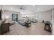 Spacious living room and dining area featuring modern decor, hardwood floors, and a ceiling fan at 789 Grand Cypress Ln, Tarpon Springs, FL 34689
