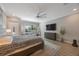 Serene main bedroom with a ceiling fan, television, dresser, and a large window at 789 Grand Cypress Ln, Tarpon Springs, FL 34689