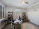 Bright office space featuring a ceiling fan, closet, and laminate floors at 789 Grand Cypress Ln, Tarpon Springs, FL 34689