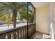 Enclosed patio offers views of palm trees and the neighborhood street, providing a serene outdoor space at 789 Grand Cypress Ln, Tarpon Springs, FL 34689