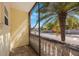 Enclosed patio offers views of palm trees and the neighborhood street, providing a serene outdoor space at 789 Grand Cypress Ln, Tarpon Springs, FL 34689