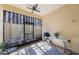 Enclosed patio featuring tile floors, ceiling fan, security camera, and furnishings perfect for relaxing outdoors at 789 Grand Cypress Ln, Tarpon Springs, FL 34689