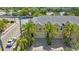 Charming townhome featuring a large driveway, attached garage, and well-manicured palm trees at 789 Grand Cypress Ln, Tarpon Springs, FL 34689