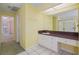 Bathroom showcasing a large vanity with ample counter space, tiled floors, and access to an en-suite bedroom at 802 Mendonsa Rd, Plant City, FL 33563
