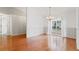 Dining room with large window, hardwood floors and neutral color palette at 802 Mendonsa Rd, Plant City, FL 33563